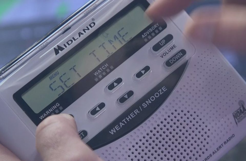 Man Setting Time On Midland NOAA Weather Radio